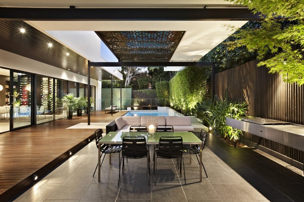 A patterned screen provides sunshade and a feature over this outdoor living space