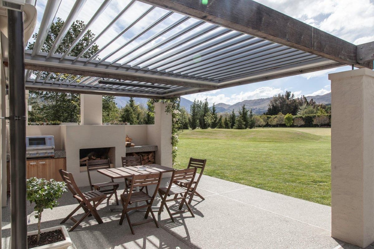 Patio with outdoor kitchen, fire, table and heaters