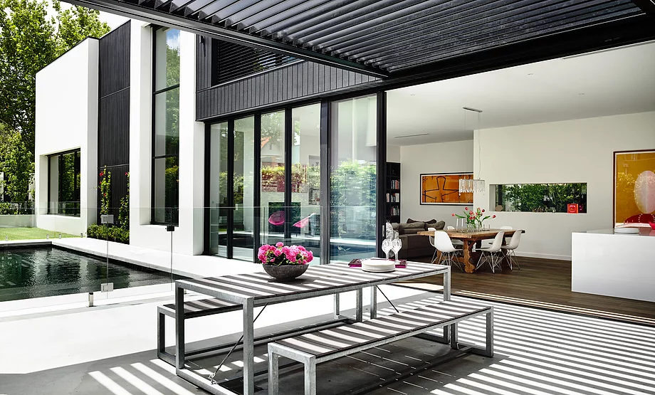 An operable louvre roof gives this outdoor living space versatility