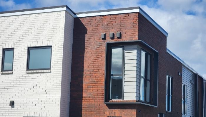 Brick townhouse with Aurae window shroud